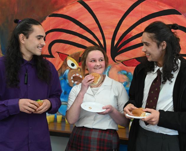 Sharing kai and conversing in te reo are (from left) Poutama Crossman-Nixon (21), and Logan Park High School pupils Bonnie Leishman (14) and younger brother Te Awa Crossman-Nixon (16), during an event to celebrate Maori Language Week at the school yesterd