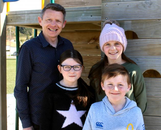 New Duntroon School principal Mike Turner with his children Ruby (9, left), Hazel (11), and George (7). Photo: Supplied