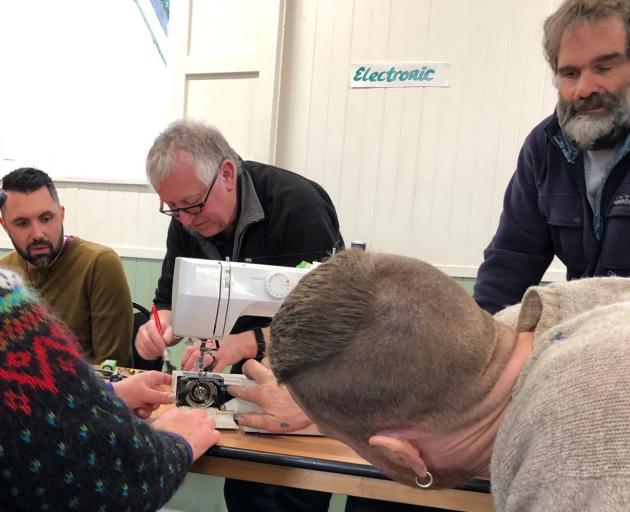 A team effort fixing a sewing machine at the Paekakariki repair cafe. Photos: Rachel Benfield 
