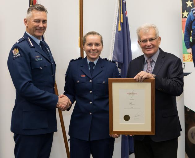 Sergeant Bridget Martin receives her Woolf Fisher Police Fellowship from (left) Commissioner of...