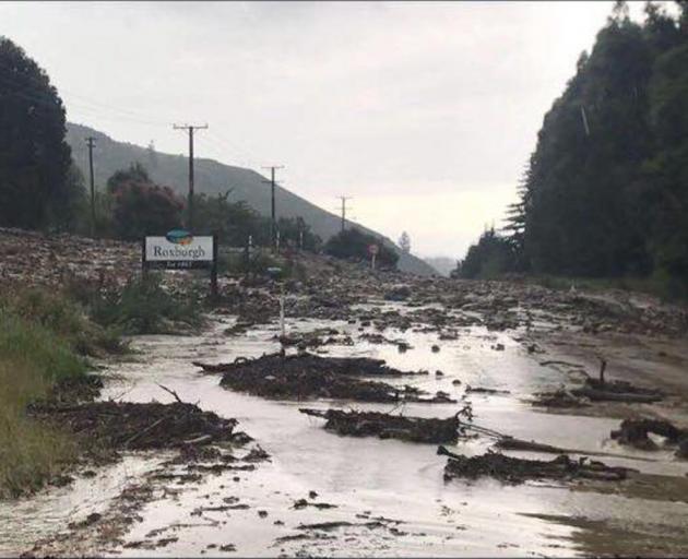 State  Highway 8  was blocked,  awash with debris yesterday. Photo: CODC