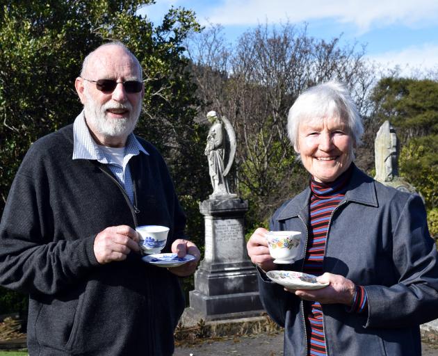 Heritage Roses Otago committee member Rex Thomson and Southern Heritage Trust trustee Ann Barsby enjoy a cuppa in Northern Cemetery in preparation for the Savoy afternoon tea next week to celebrate the replanting of heritage roses in the cemetery. Photo: 