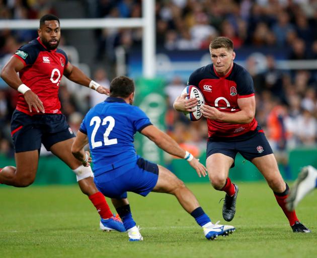 England's Owen Farrell in action with Italy's Guglielmo Palazzani Action Photo: Images via Reuters