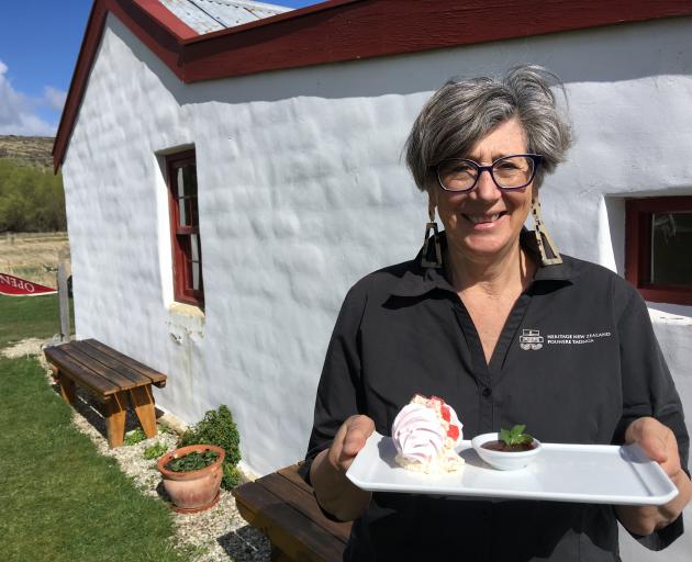 Hannah's Cafe visitor host Kaye Gray shows off the cafe's Eat. Taste. Central. meringue dessert...