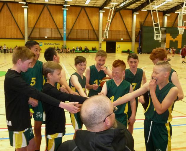 The Mid Canterbury U13 boys A grade team gets a team talk from coach Ben Ditmer ahead of their 89...