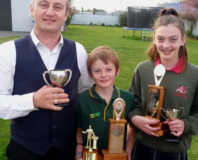 Winning speech makers: Phil, Leon and Taymah Wheeler with their haul of trophies. Photo: Mick Jensen