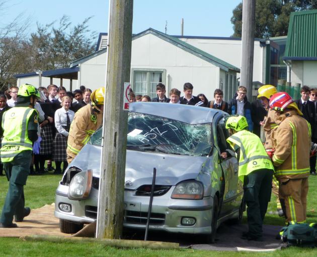 Seniors students at Mount Hutt College watch on as emergency services work at the scene of the...