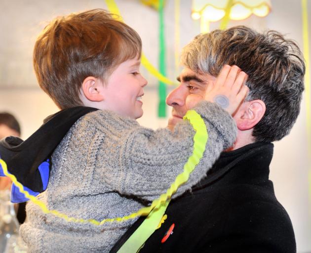 Dunedin Mayor-elect Aaron Hawkins is greeted by his son, Emile, at a victory party in a Dunedin...