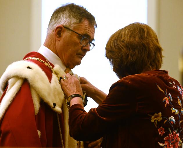 Dave Cull's wife, Joan Wilson, adjusts his robes. Photo: Linda Robertson