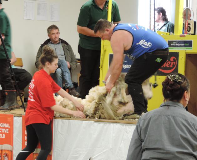 Lucy Avery, of Waimate, gathers the fleece shorn by Bill Melville, of Waimate, in the junior...