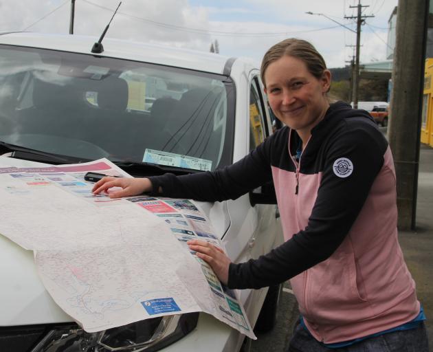 Environment Southland environmental education officer Hannah Sim looks over a map of Northern Southland, where she is about to provide an environmental camp through beef, deer and wind farms, wetlands and Fiordland National Park on November 25 and 26. Pho