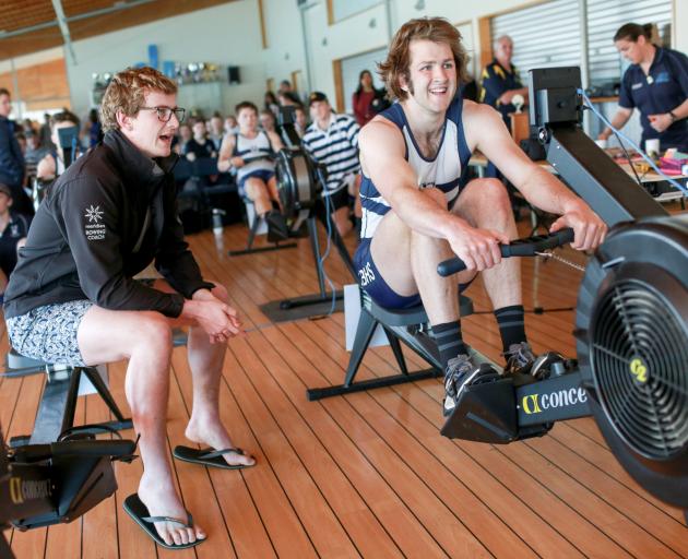 Otago Boys' High School rower Oliver Haig digs in, encouraged by his brother Chris, while...