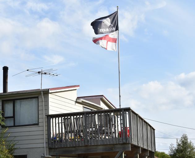 Rival flags wave above the News’ Dunedin house. PHOTOS: GREGOR RICHARDSON
