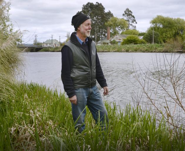 Henley resident Allan Innes stands on a flood bank protecting the settlement. Photos: Gerard O...