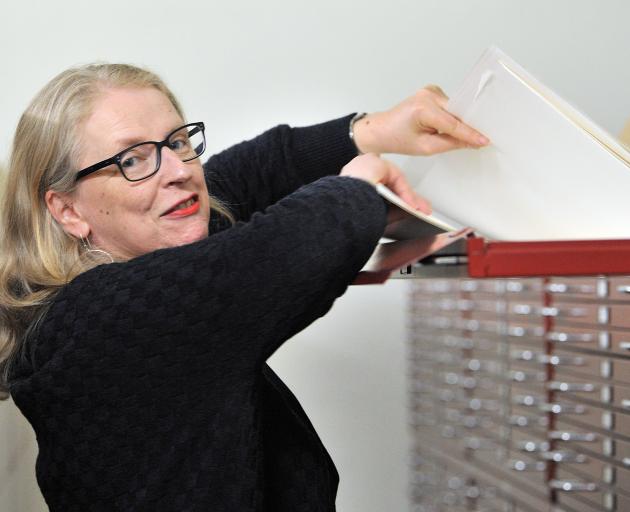 Hocken Library archives head curator Anna Blackman peruses the Salmond Architects Collection....