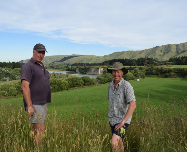 Hurunui farmer Dave Holland, left, with Rural Advocacy Network chairman Jamie McFadden. Mr Holland's pasture below them, beside the Hurunui River, would have been considered riverbed under ECan's 1-in-50 year flood modelling. Photo: File