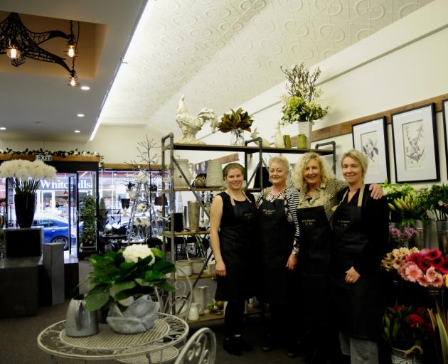 Fi Sidey, third from left, the owner of Fi's Flowers 'n' Art, with her staff, from left, Vivienne Williams, Roslyn Harris, and Sharon MacDonald. Photo: Shelley Topp