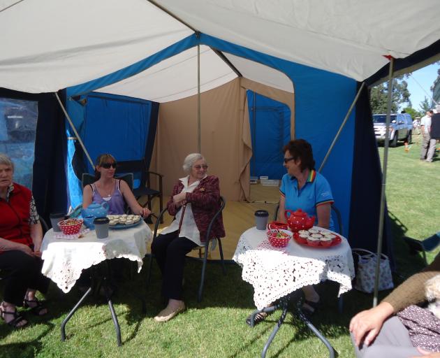 Adriel residents and staff enjoy a chat in the shade at last year’s Amberley A&P Show. Photo: Supplied