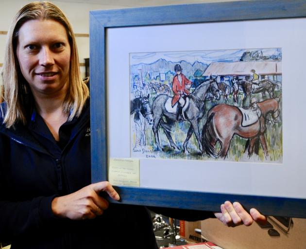 A 2004 watercolour by June Douglas is held by Kerryn Larwood, office administrator at the Bells Auction House in Kaiapoi. The painting is included in a large antique sale being held at the auction house on Wednesday next week. Photos: Shelley Topp