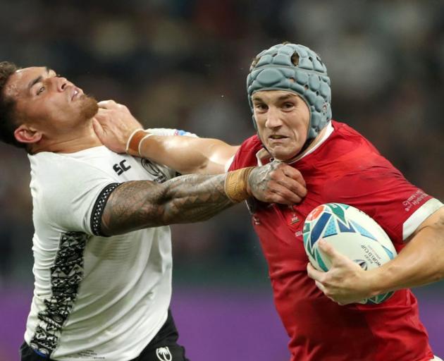 Jonathan Davies of Wales fends off Jale Vatubua of Fiji during their match last night. Photo:...
