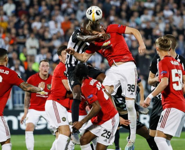 Umar Sadiq (left) of Partizan contests the ball against Scott McTominay (right) of Manchester...