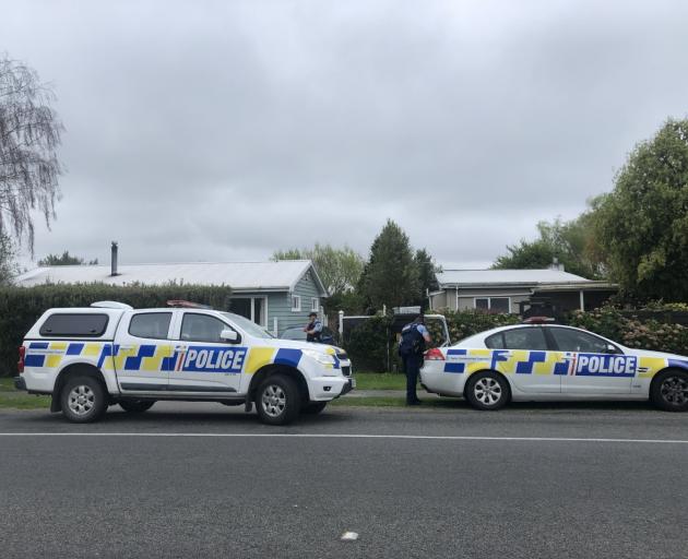 Police outside Benbow's property on the day he was arrested. 