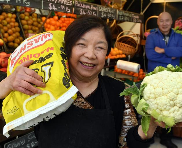 Nancy Young in the Balclutha greengrocers she and her late husband Ngok opened 50 years ago. Son and business partner Roger stands behind. Photo: Stephen Jaquiery