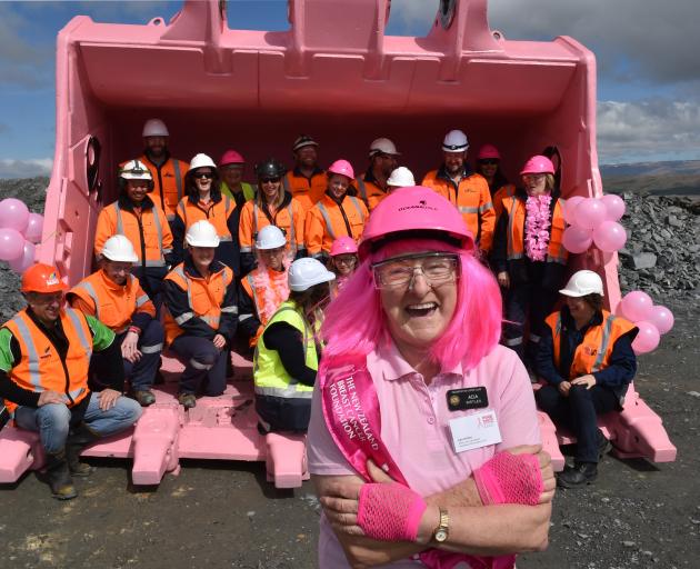 Ada Birtle, of the Palmerston Lions Club and Pink Ribbon appeal, with 22 engineers, painters and miners who squeezed into a 22-tonne digger bucket at Macraes Goldfield. Photo: Gregor Richardson