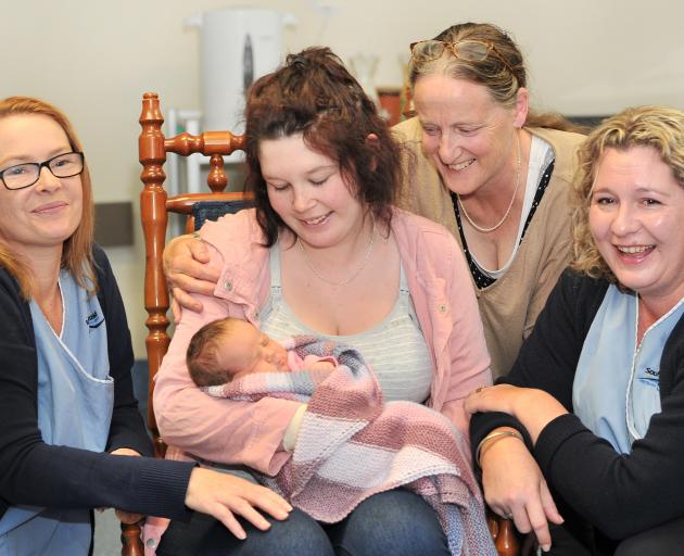 Queen Mary midwives Deborah Palmer (left) and Fiona Mair (right) flank new mum Danielle Cairns, 2...
