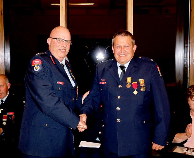 Leeston volunteer firefighter Roger Sheat being presented with his gold star for 25 years of...