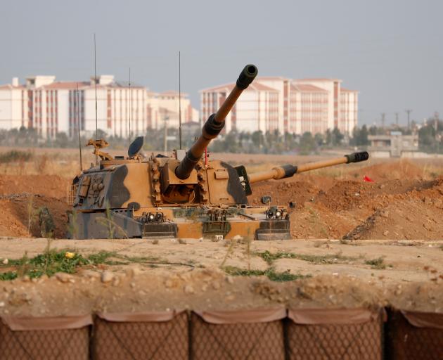 A Turkish army howitzer is positioned near the Turkish-Syrian border in Sanliurfa province. Photo...