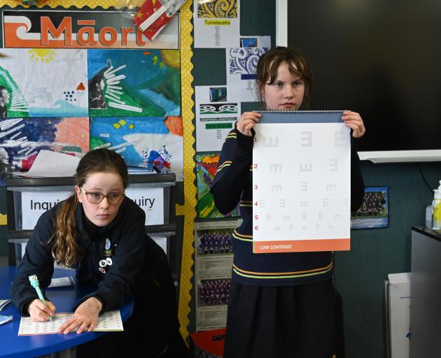 Writing down test results is Sophie Low (12) as Temple Chirnside (12) holds the vision chart. Photos: Linda Robertson