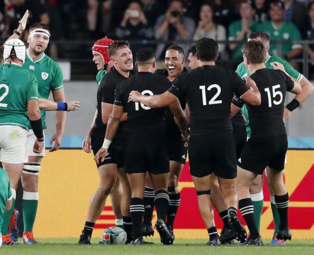 The All Blacks congratulate George Bridge during their comprehensive win over Ireland in Tokyo....