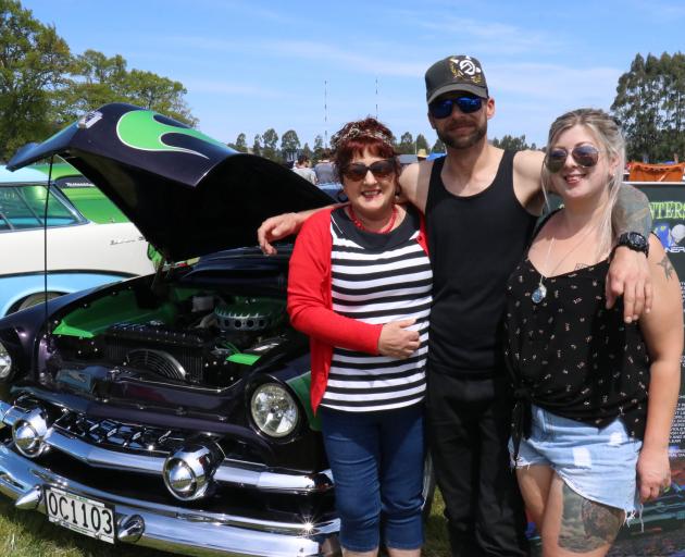 Lavina (left) and Brad Bisschop with Sasha Jones and their alien-themed 1952 Ford Twin Spinner at...