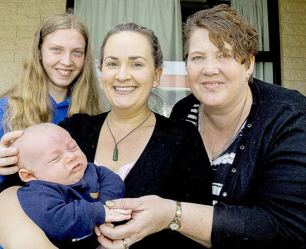 Jenny Pascoe (centre) was helped when she was struggling at the supermarket with her baby Olli by...