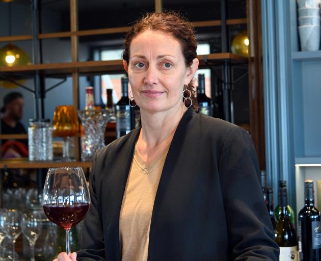 Katrina Toovey contemplates the many bottles of wine, spirits and glasses that need to be shelved before the reopening. Photos: Supplied