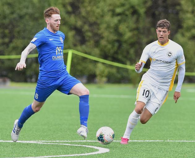 Southern United striker Garbhan Coughlan (left) looks to move the ball on in front of Eastern...