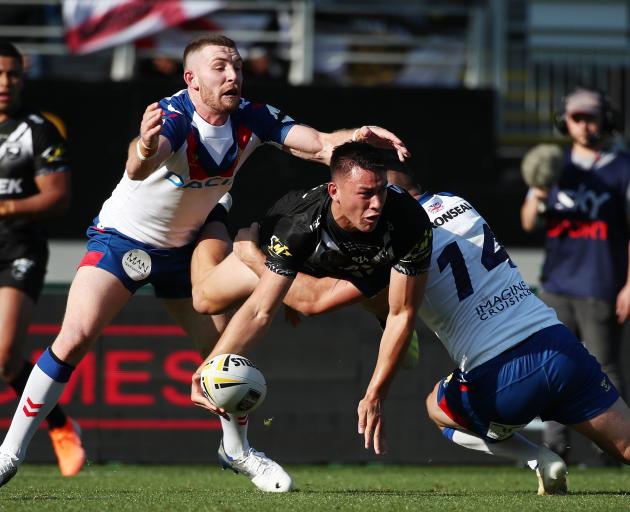 Jahrome Hughes of the Kiwis looks for the offload while airborne. Photo: Getty Images 