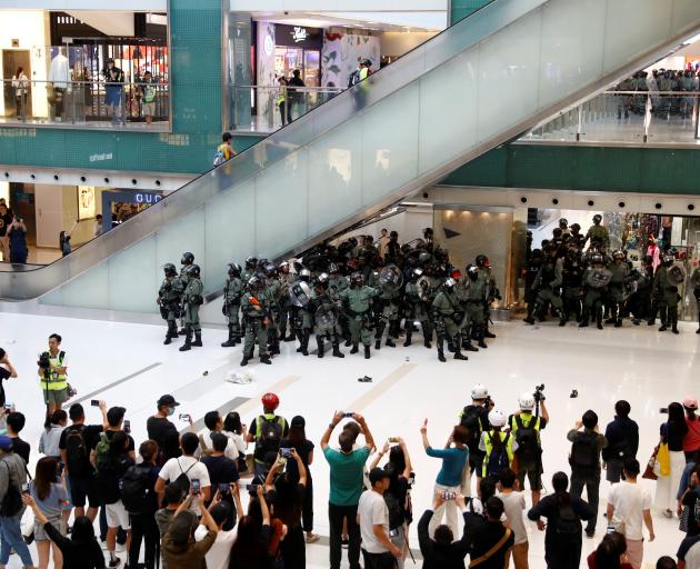 Shoppers and anti-government protesters gather at New Town Plaza in Sha Tin, Hong Kong. Photo: Reuters