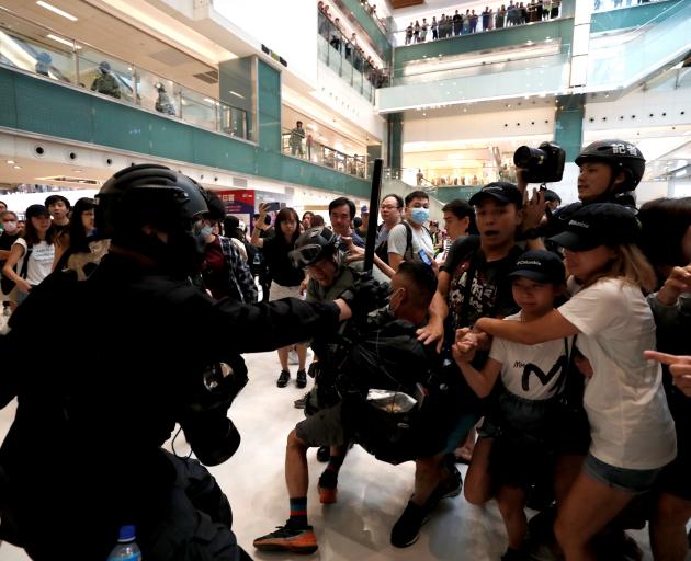 Shoppers and anti-government protesters gather at New Town Plaza in Sha Tin, Hong Kong. Photo: Reuters