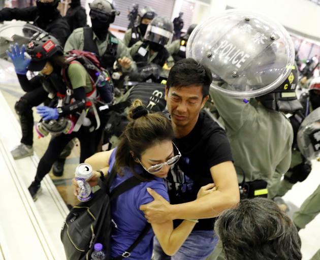 People scuffle with riot police at a shopping mall in Tai Po in Hong Kong. Photo: Reuters