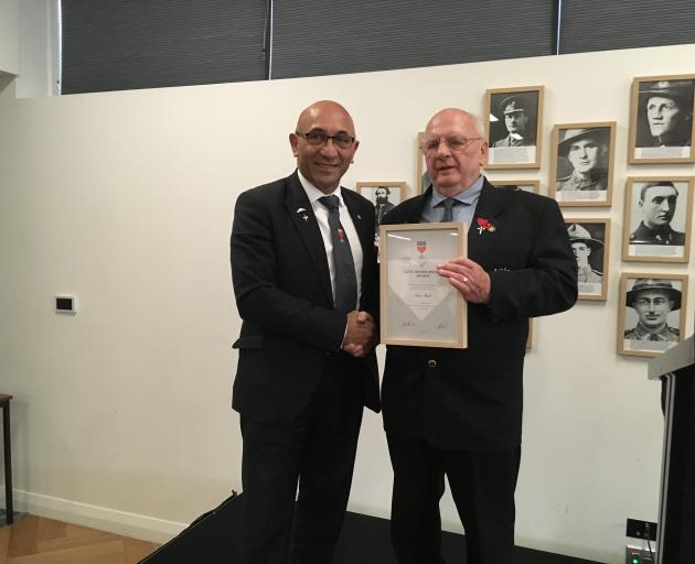 Rangiora RSA president Ian Thompson, right, presents Defence and Veterans Affairs Minister Ron...