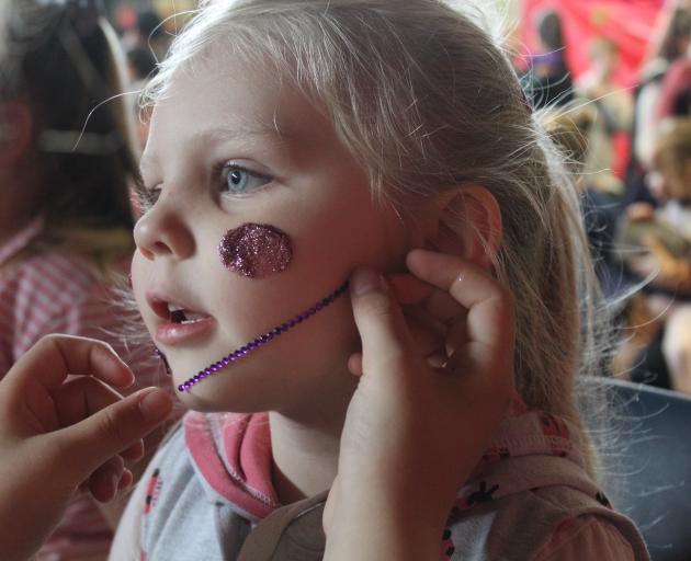 Opting for pinks and purples, Alexia Simpson (3) enjoyed having her face painted at the carnival...