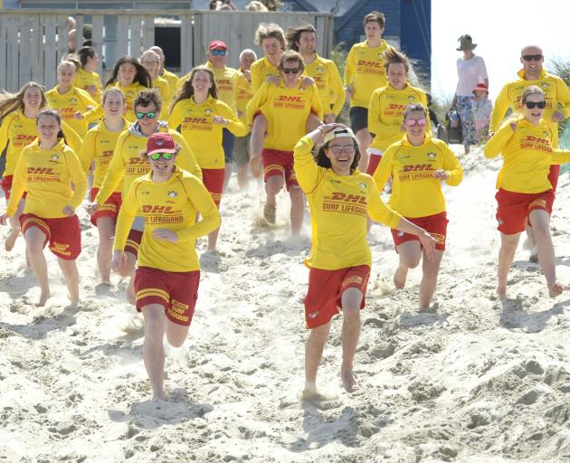 Members of the St Kilda Surf Life Saving Club race from the clubrooms to the beach. PHOTO: GERARD...