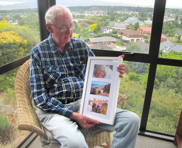 Ken Cook looks at photos of his wife Jeanette. Mrs Cook has advanced dementia and is in full-time...