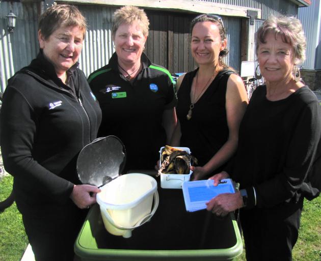 Looking over a new community worm farm facility in Clyde are (from left) Bike It Now co-owners...