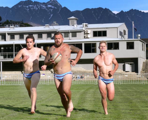 Wakatipu Rugby Club players (from left) Tom Ellis, Rhys Kearton and Logan Beggs stretch their...