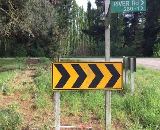 A 6-year-old boy died after a car failed to take the bend at Lehmans Rd and River Rd near Rangiora on Tuesday and launched over a river stop bank. Police are investigating. Photo: NZ Herald