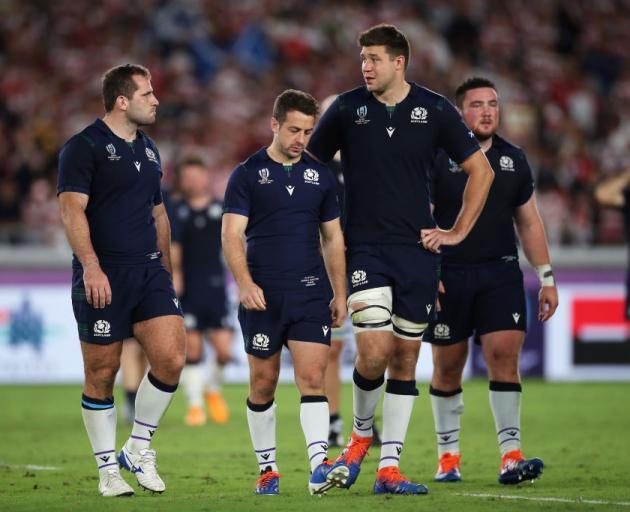 Scotland players Fraser Brown, Greig Laidlaw and Grant Gilchrist walk off the field after losing...