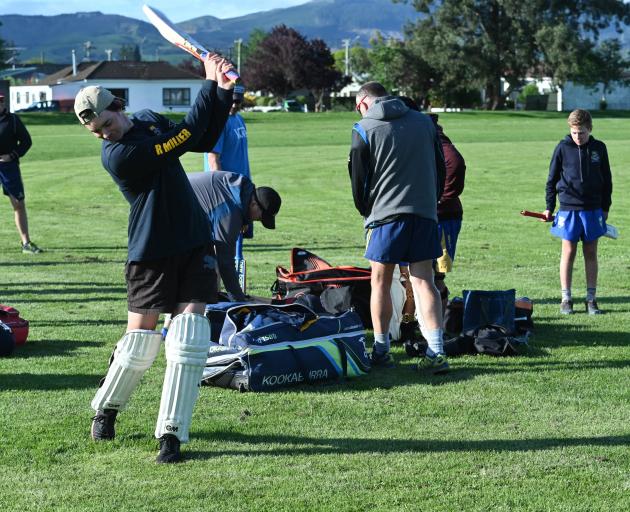 Regan Miller gets in a practice swing before batting for the Heat in the opening match of a new...